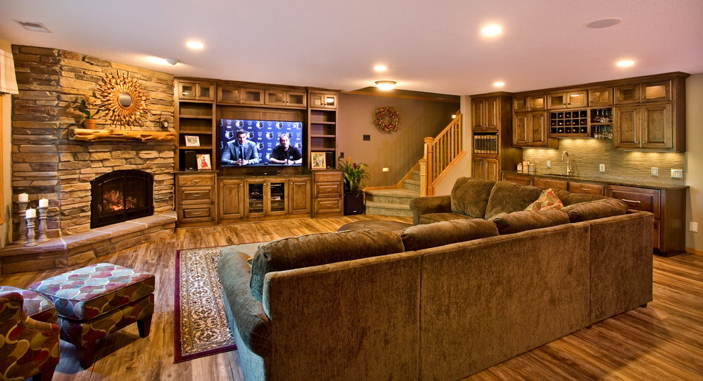 Medium sized traditional look-out basement in Minneapolis with beige walls, a standard fireplace, a stone fireplace surround and dark hardwood flooring.