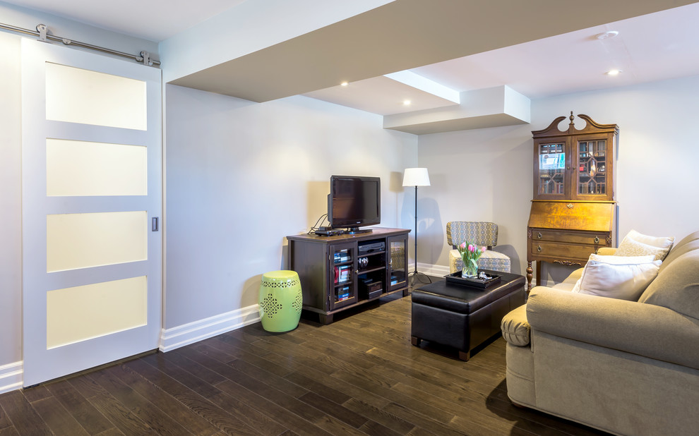 Design ideas for a small traditional look-out basement in Toronto with grey walls and dark hardwood flooring.