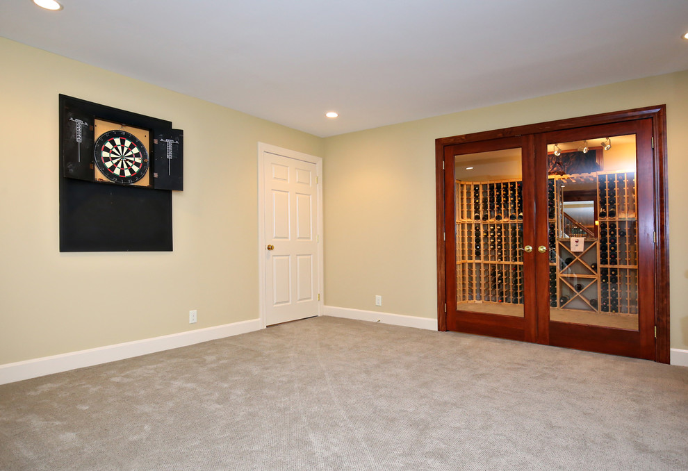Photo of a traditional look-out basement in Louisville with yellow walls, carpet and no fireplace.