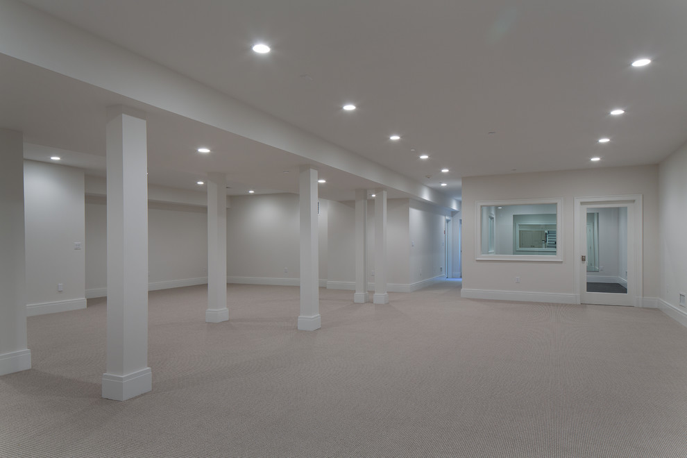 Example of a large transitional underground carpeted basement design in New York with gray walls and no fireplace