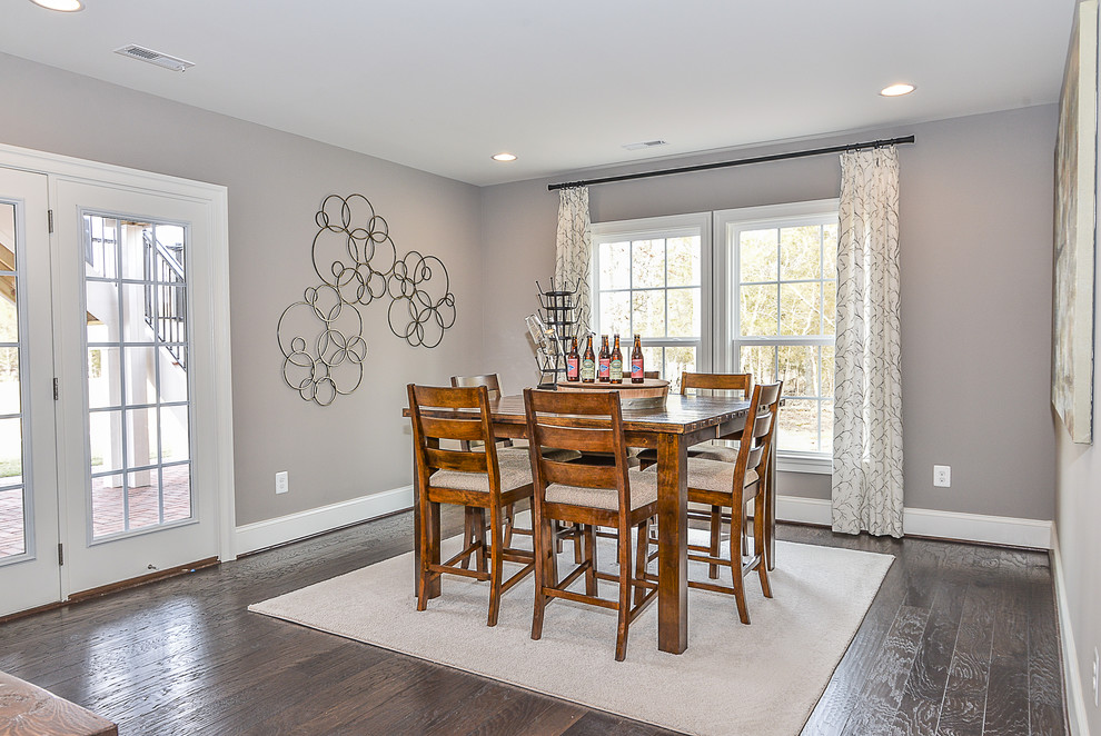 This is an example of a medium sized traditional dining room in DC Metro with grey walls, dark hardwood flooring, a ribbon fireplace and a tiled fireplace surround.