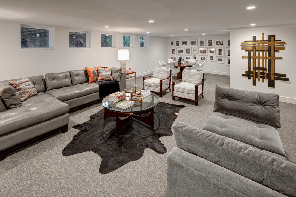 Photo of a large retro look-out basement in Detroit with white walls, carpet, no fireplace and grey floors.