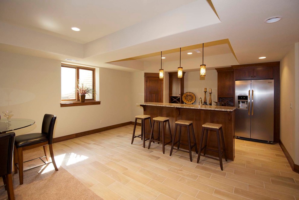 Basement - large traditional look-out ceramic tile and beige floor basement idea in Milwaukee with beige walls and no fireplace