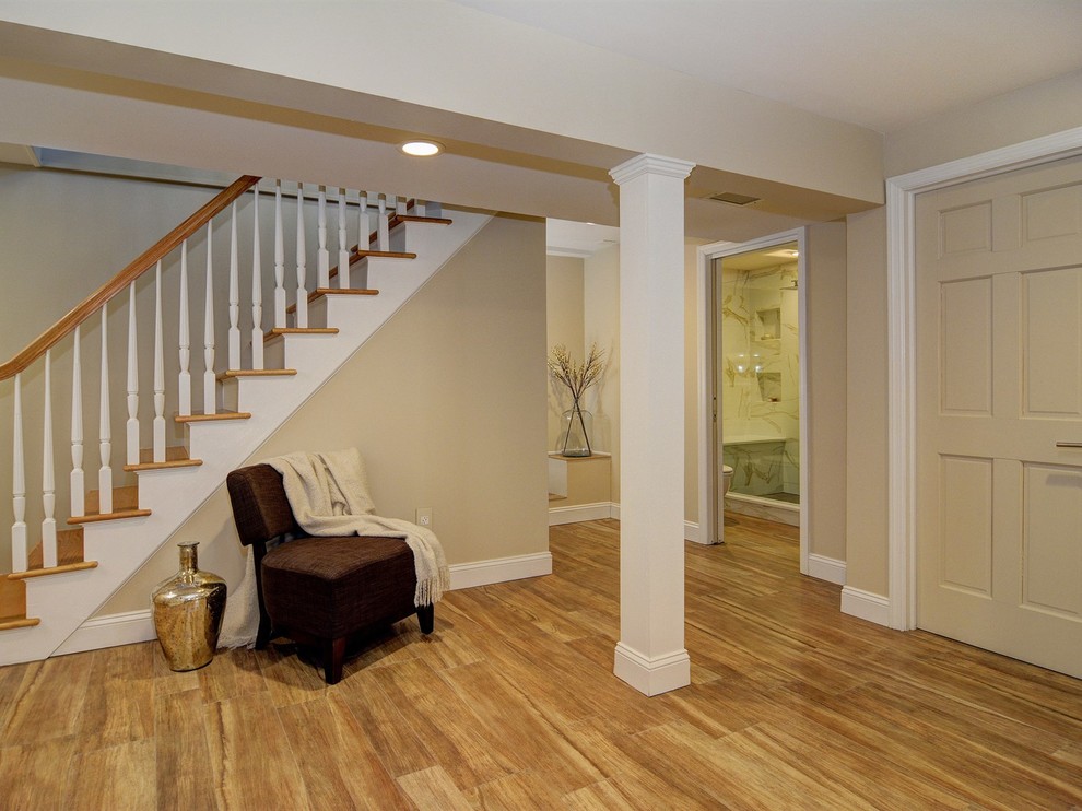 Example of a huge transitional look-out porcelain tile basement design in Newark with beige walls and no fireplace