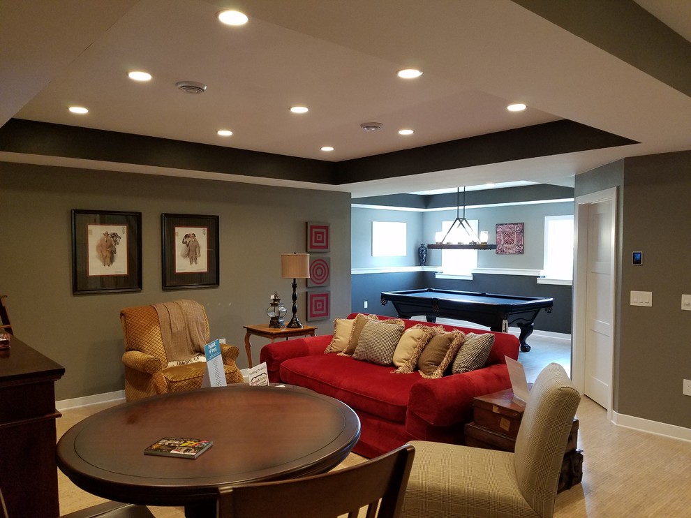 This is an example of a large contemporary look-out basement in Milwaukee with grey walls, cork flooring and multi-coloured floors.