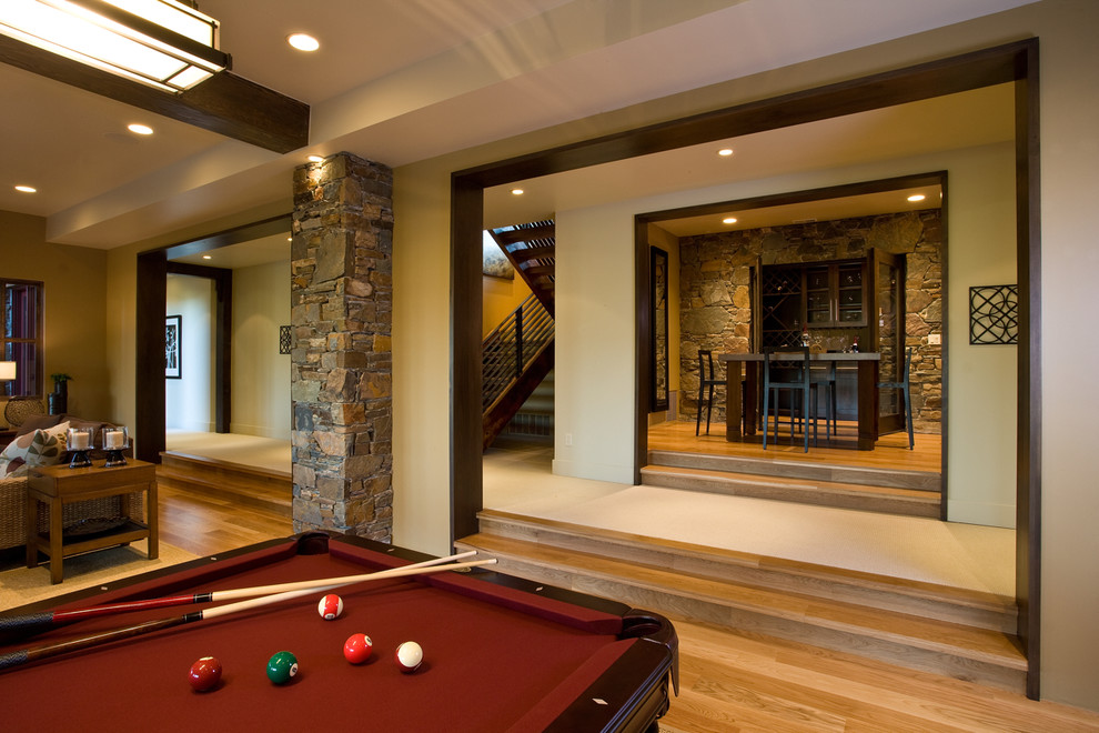 This is an example of a rustic games room in Salt Lake City with beige walls and medium hardwood flooring.
