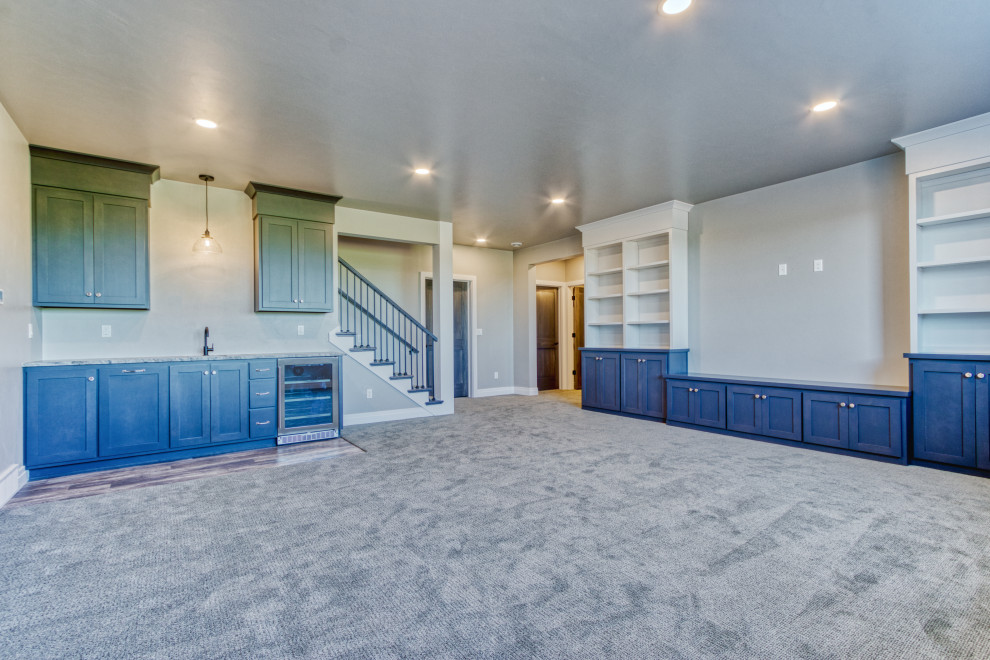 Inspiration for a mid-sized transitional look-out carpeted basement remodel in Other with a bar and gray walls