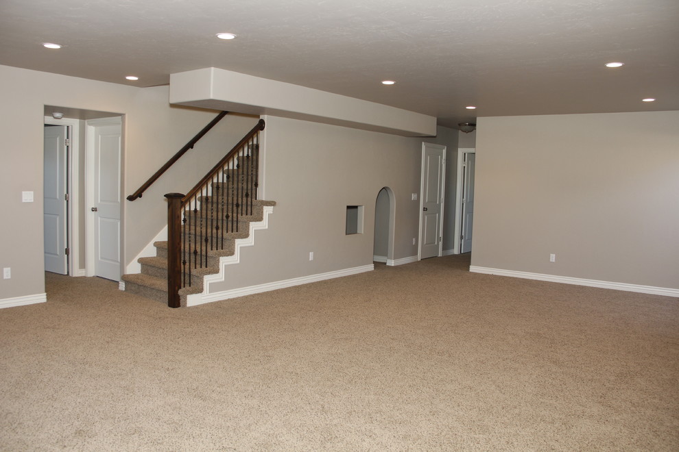 Large arts and crafts underground carpeted basement photo in Salt Lake City with gray walls