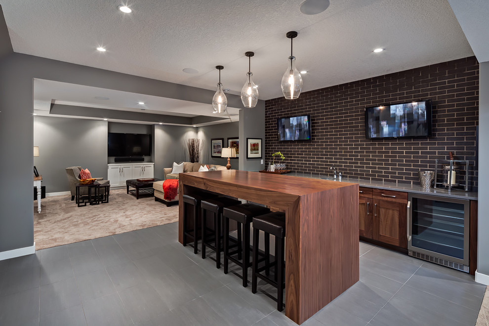 Transitional underground gray floor basement photo in Calgary with gray walls and no fireplace