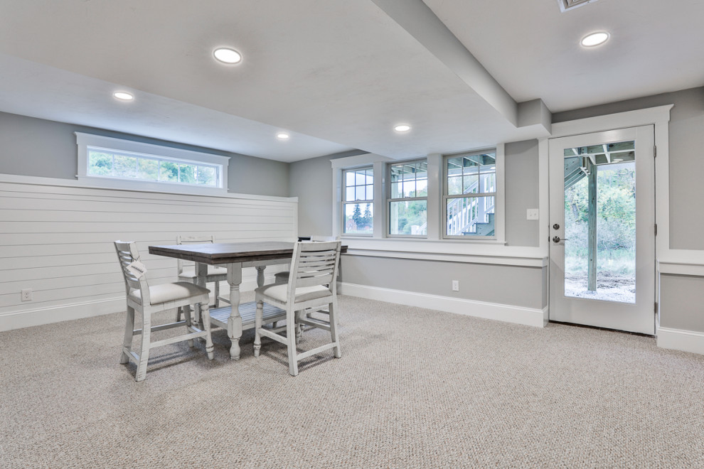 Design ideas for a classic walk-out basement in Boston with grey walls, carpet and white floors.