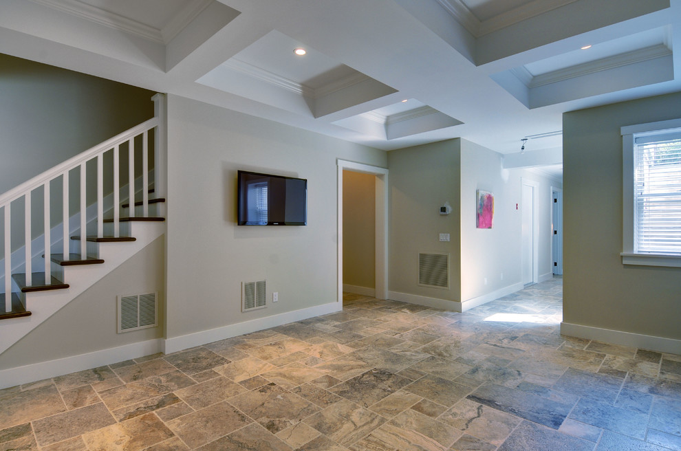 Large elegant walk-out travertine floor basement photo in Manchester with beige walls and no fireplace