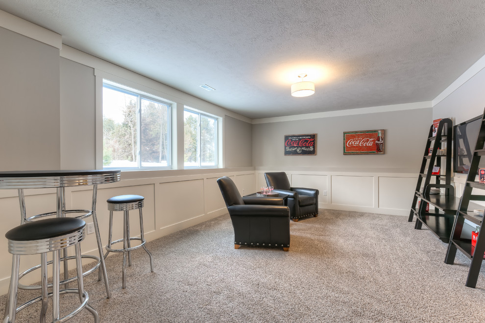 Photo of a traditional look-out basement in Grand Rapids with grey walls and carpet.