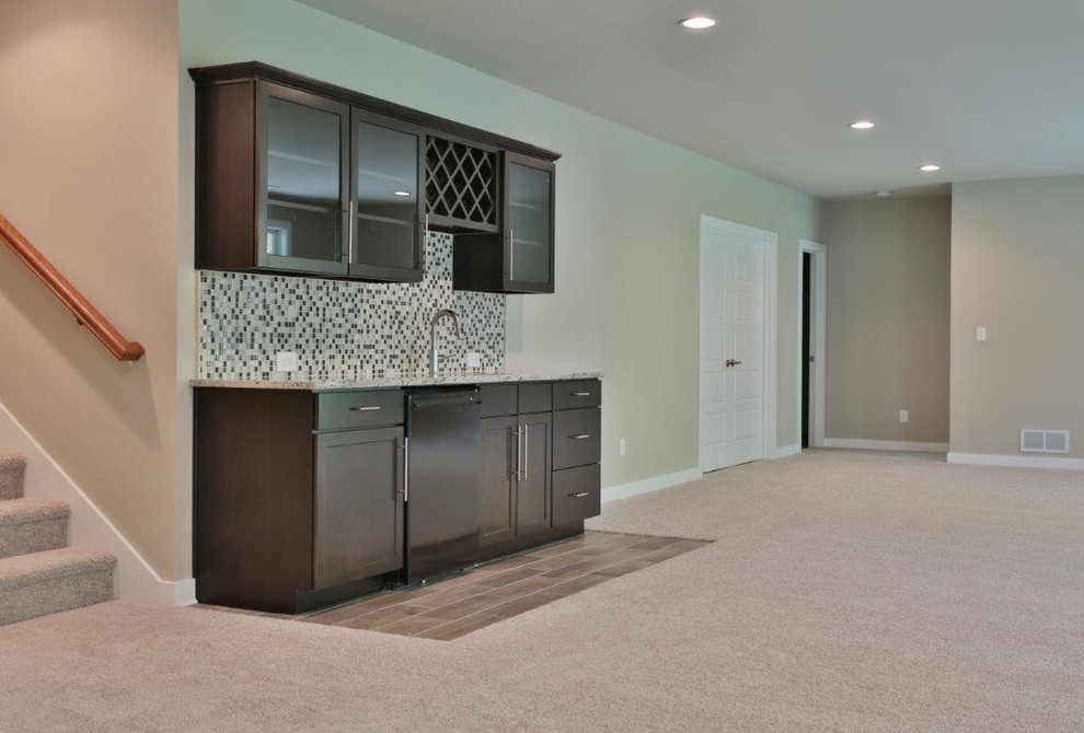 Photo of a large classic walk-out basement in Louisville with grey walls and carpet.