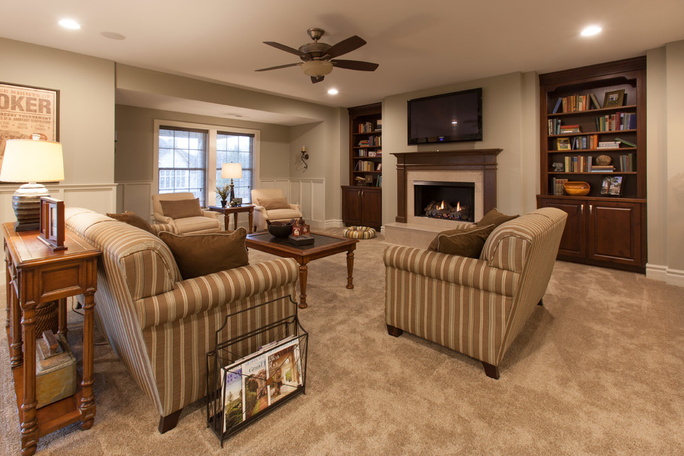 This is an example of an expansive contemporary walk-out basement in St Louis with beige walls, carpet, a standard fireplace and a tiled fireplace surround.