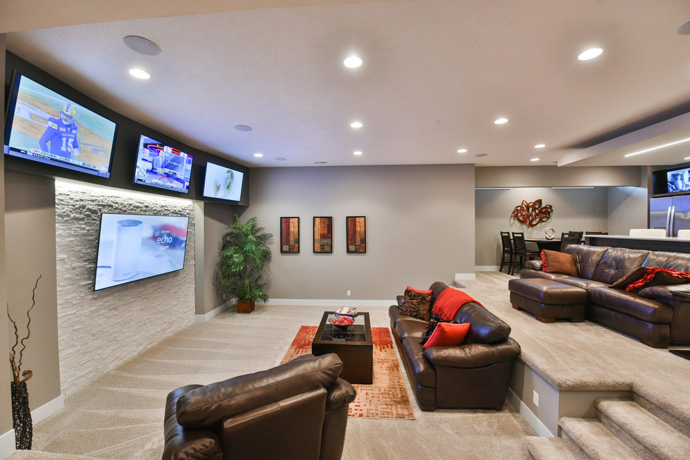 Mid-sized transitional underground carpeted and beige floor basement photo in Omaha with gray walls, no fireplace and a home theater