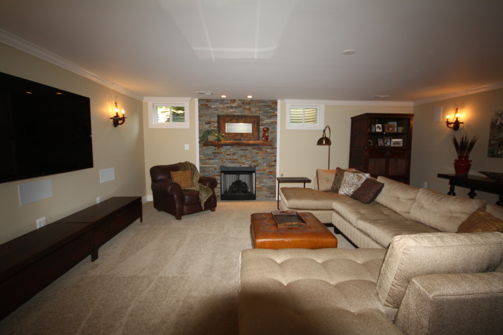 Large mountain style walk-out carpeted basement photo in DC Metro with beige walls, a standard fireplace and a stone fireplace