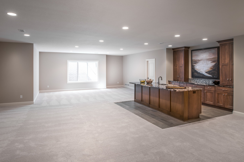 Photo of a large traditional basement in Wichita with beige walls, carpet and beige floors.