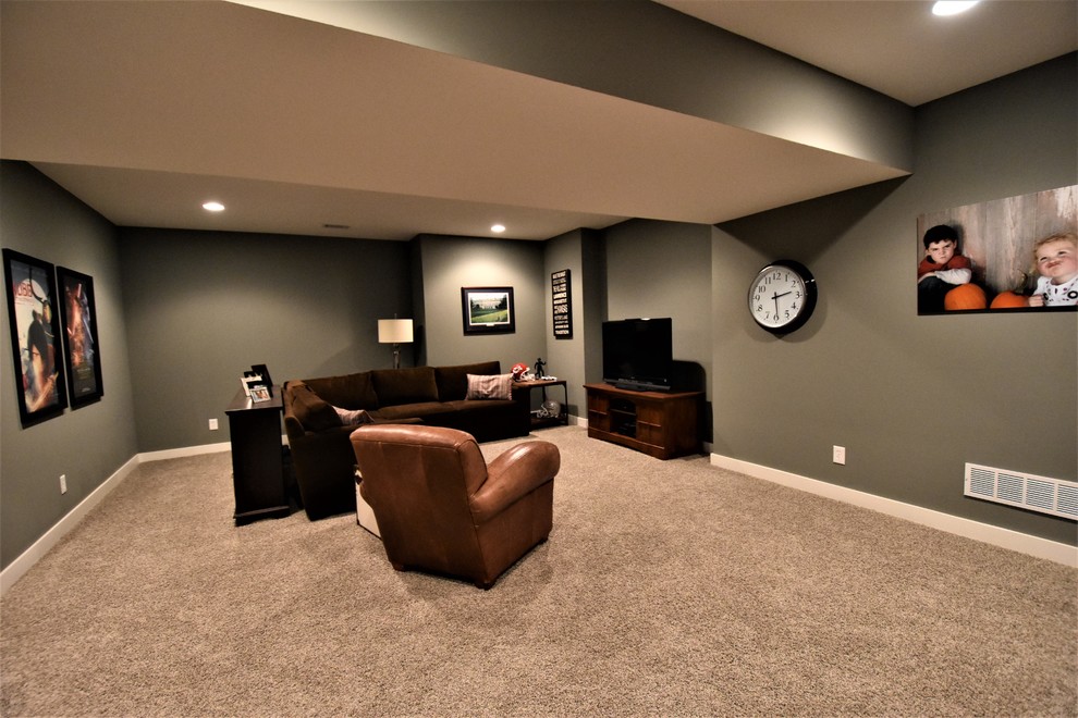 Inspiration for a large craftsman underground carpeted basement remodel in Kansas City with gray walls and no fireplace
