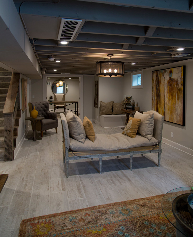 This is an example of a large rural fully buried basement in Kansas City with grey walls, light hardwood flooring, grey floors and feature lighting.