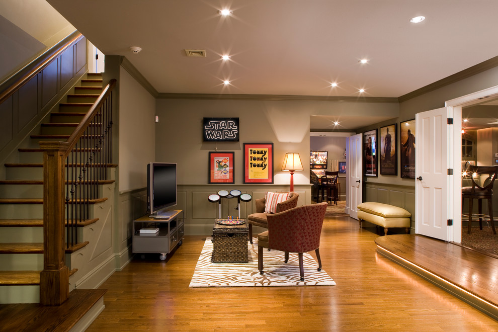 Elegant underground medium tone wood floor basement photo in New York with gray walls and no fireplace