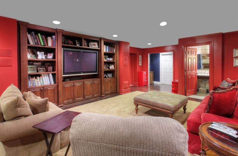 Example of a mid-sized transitional underground carpeted basement design in Las Vegas with red walls