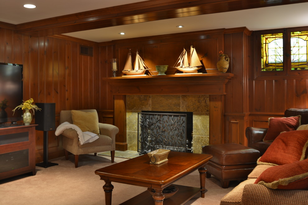 Example of a large classic walk-out beige floor and carpeted basement design in Milwaukee with a standard fireplace, a tile fireplace and brown walls