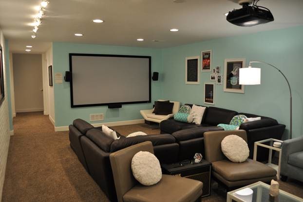 Cette photo montre une salle de cinéma chic de taille moyenne avec un mur bleu et moquette.