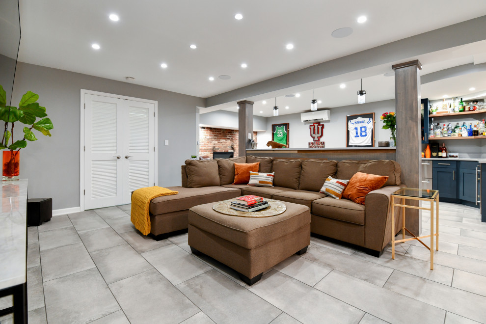 Large transitional porcelain tile and gray floor basement photo in DC Metro with a bar, gray walls, a standard fireplace and a brick fireplace