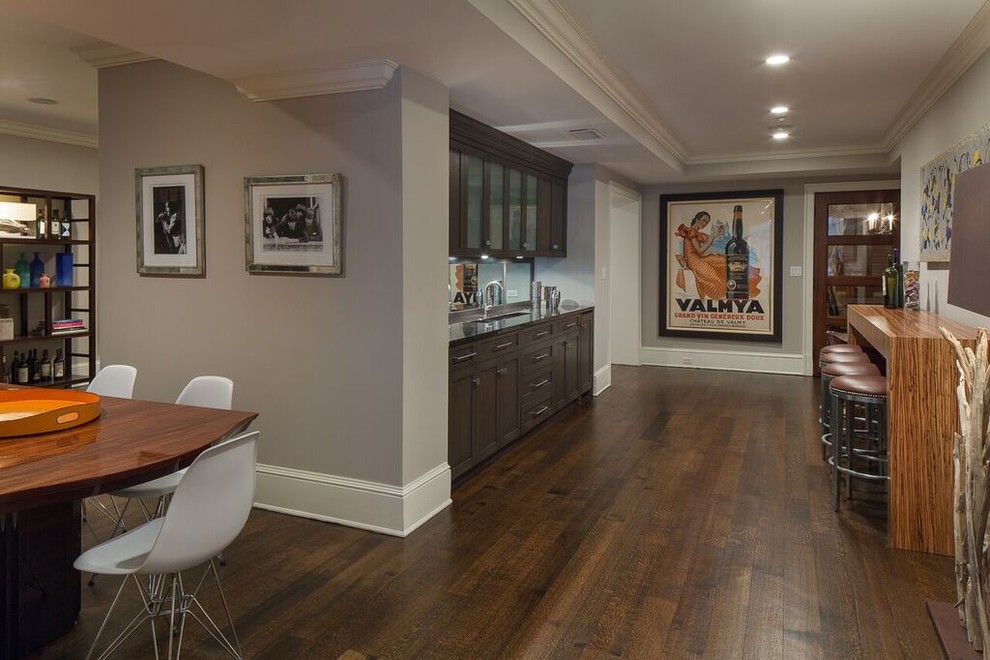 Inspiration for a large transitional look-out dark wood floor and brown floor basement remodel in New York with gray walls