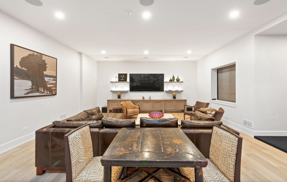This is an example of a large traditional fully buried basement in Chicago with white walls, vinyl flooring and brown floors.