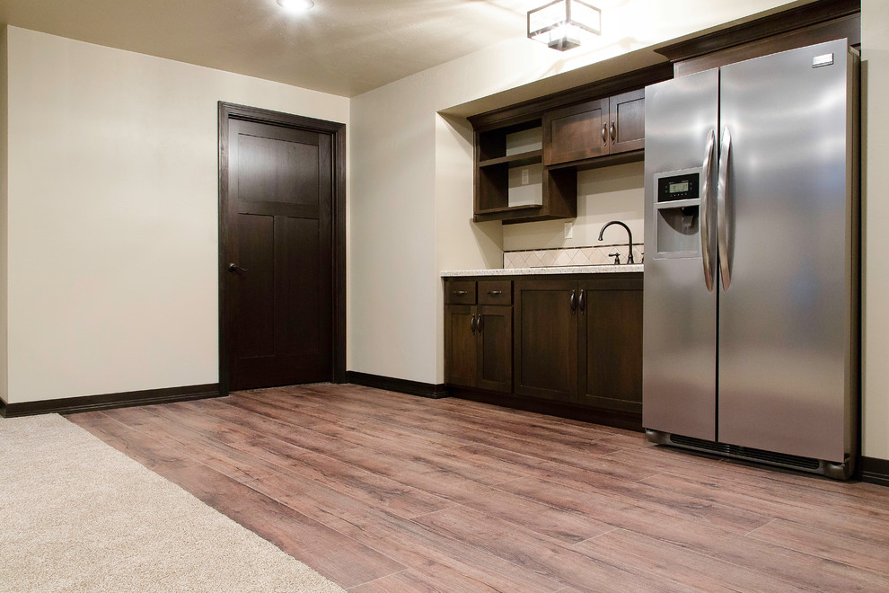 This is an example of a medium sized traditional basement in Other with white walls, vinyl flooring, no fireplace and brown floors.
