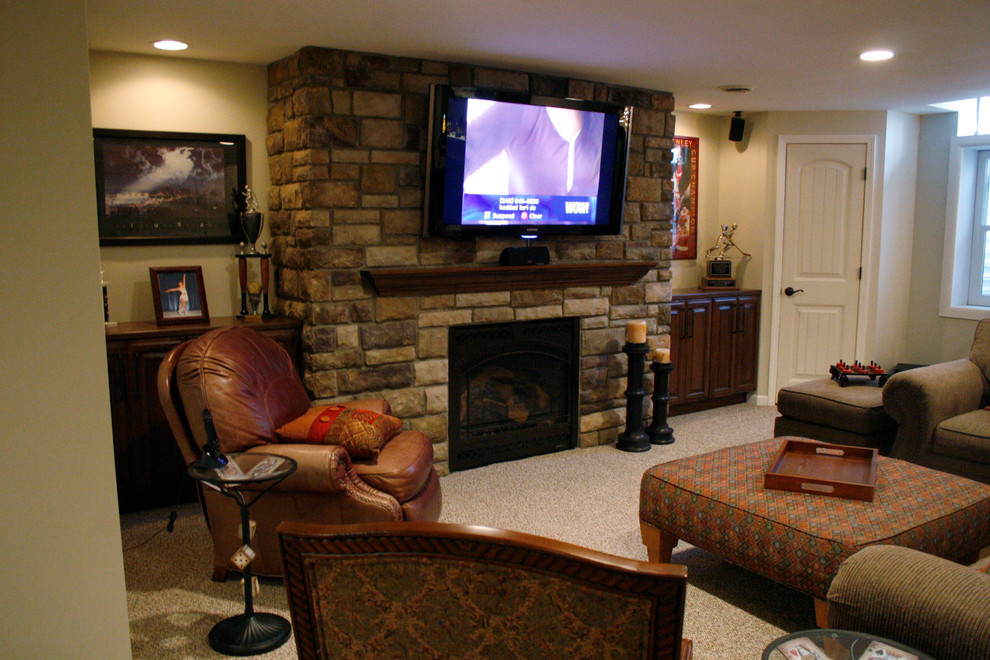 Example of a huge trendy underground carpeted basement design in Detroit with beige walls, a standard fireplace and a stone fireplace