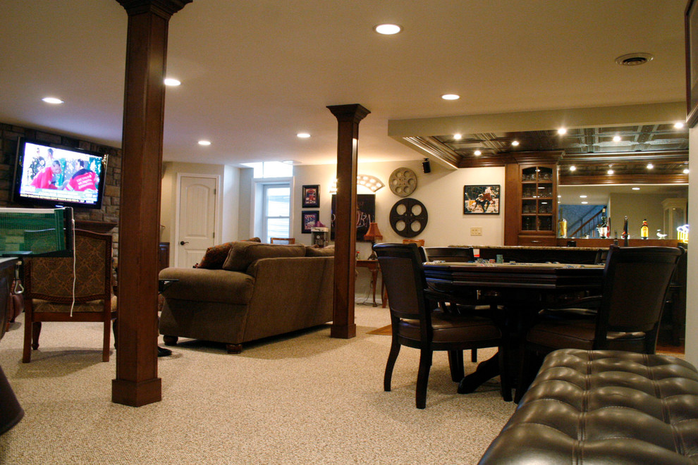 Photo of an expansive contemporary fully buried basement in Detroit with beige walls, carpet, a standard fireplace and a stone fireplace surround.