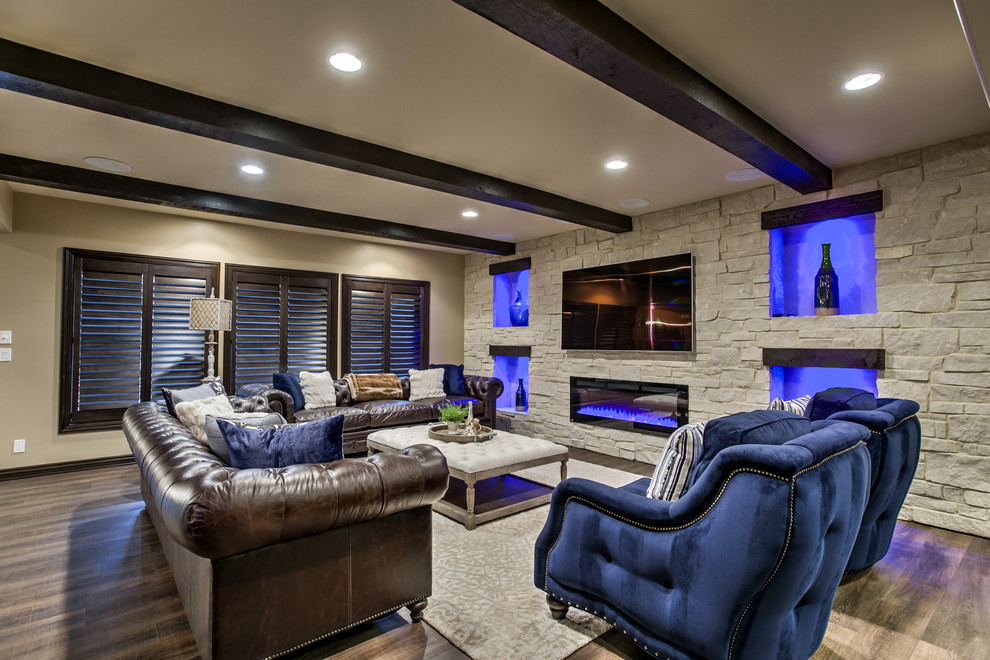 Classic walk-out basement in Omaha with a ribbon fireplace and a stone fireplace surround.