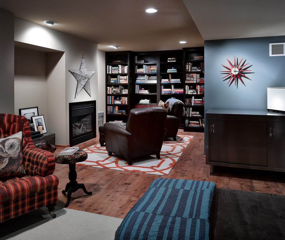 Photo of a medium sized classic fully buried basement in Other with blue walls, a standard fireplace, a metal fireplace surround and vinyl flooring.