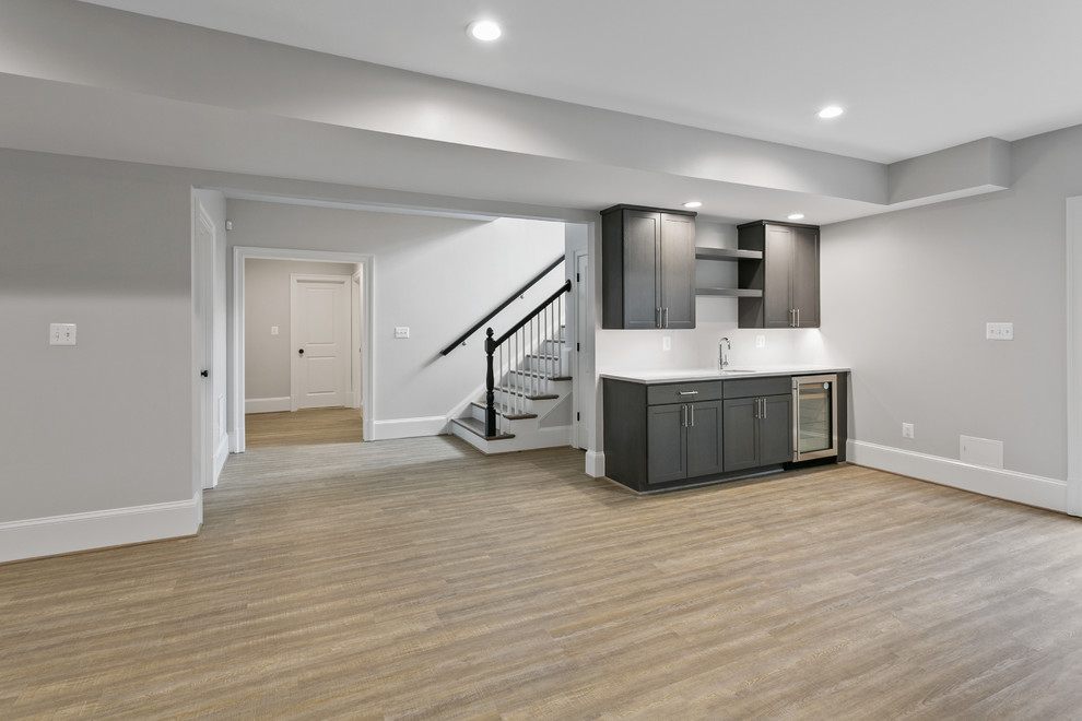 Design ideas for a medium sized contemporary walk-out basement in Other with white walls, medium hardwood flooring and brown floors.