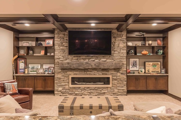 Large traditional look-out basement in Detroit with beige walls, carpet, a standard fireplace, a stone fireplace surround and beige floors.