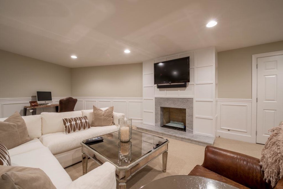 Large elegant underground carpeted basement photo in Philadelphia with beige walls, a standard fireplace and a stone fireplace