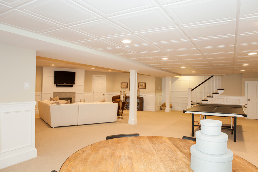 Photo of a large traditional fully buried basement in Philadelphia with beige walls, carpet, a standard fireplace and a stone fireplace surround.