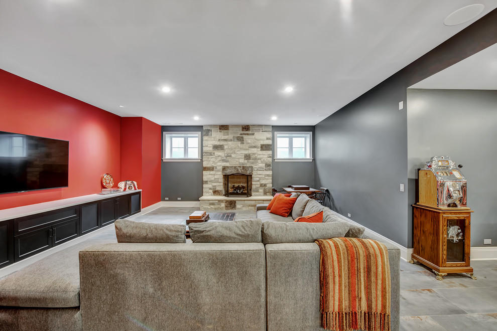 Large elegant look-out ceramic tile and gray floor basement photo in Chicago with red walls, a standard fireplace and a stone fireplace