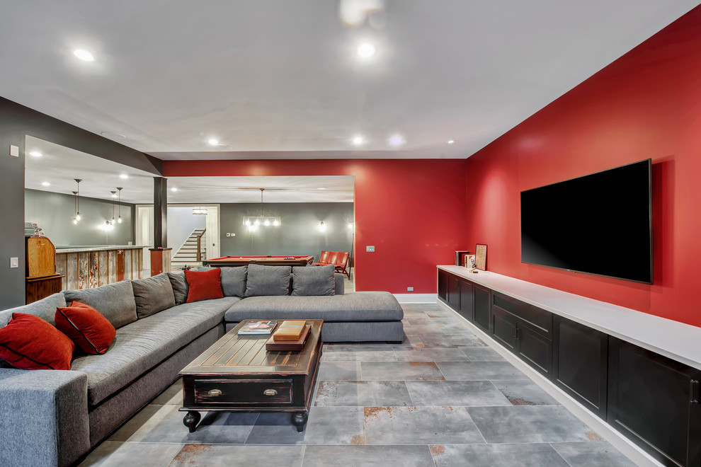 Example of a large classic look-out ceramic tile and gray floor basement design in Chicago with red walls, a standard fireplace and a stone fireplace