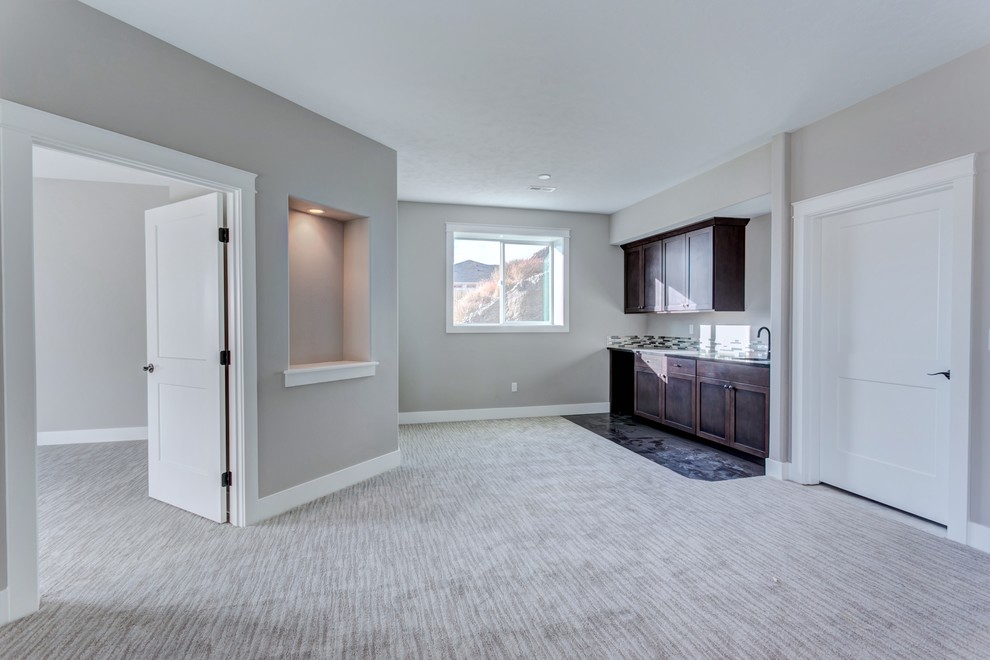 Example of a large arts and crafts walk-out carpeted and gray floor basement design in Seattle with gray walls and no fireplace