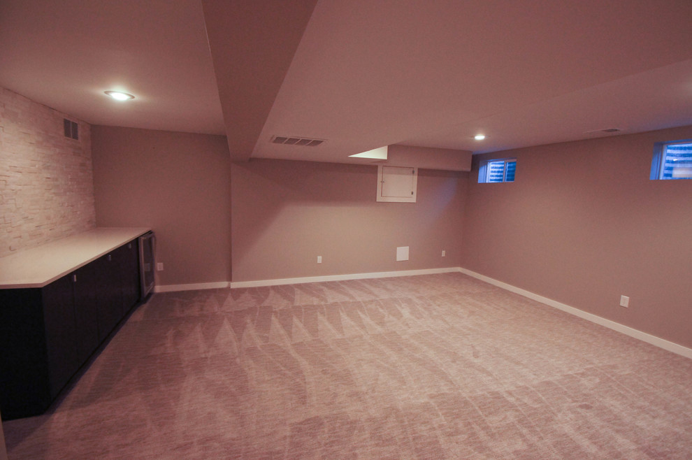Design ideas for a large modern fully buried basement in Other with grey walls and carpet.