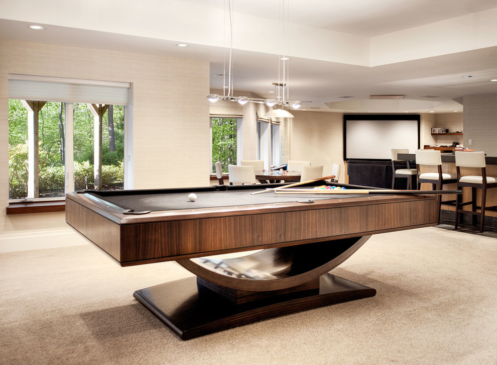 Basement game room - huge contemporary walk-out carpeted and beige floor basement game room idea in New York with beige walls