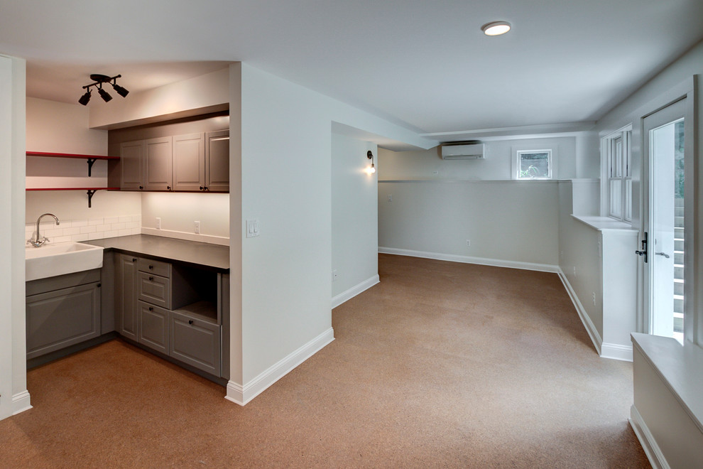 Medium sized contemporary walk-out basement in Boston with grey walls and cork flooring.