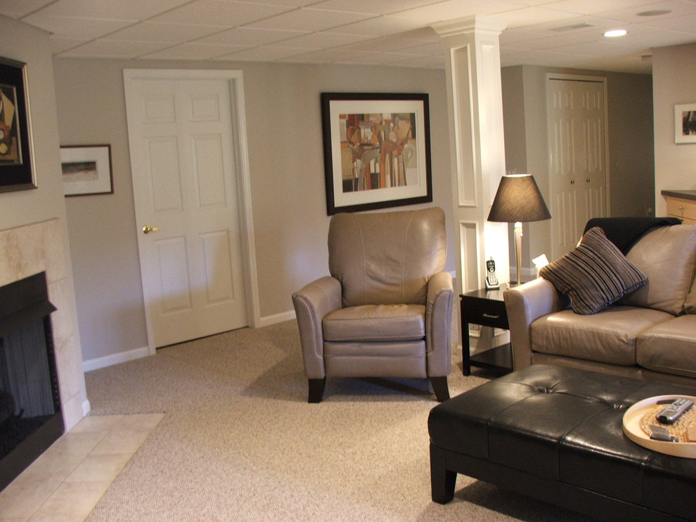 Example of a large classic basement design in Detroit with beige walls and a standard fireplace