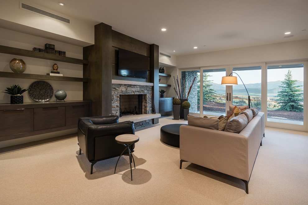 Inspiration for a medium sized contemporary walk-out basement in Salt Lake City with white walls, carpet, a standard fireplace, a stone fireplace surround, beige floors and a chimney breast.