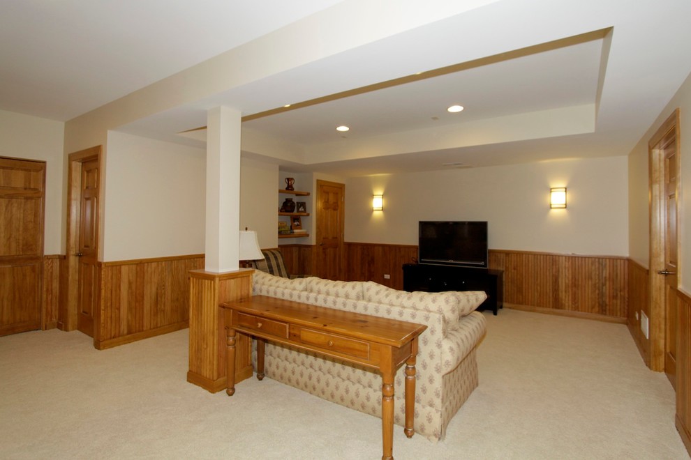 Photo of a large classic fully buried basement in Chicago with beige walls and carpet.