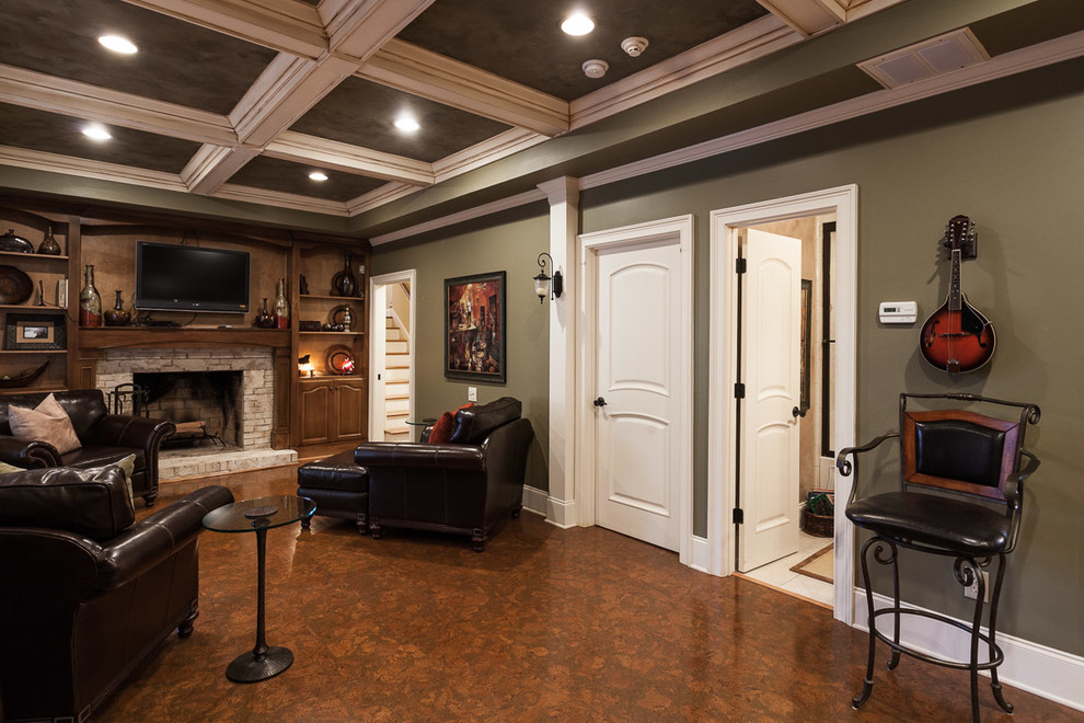 Aménagement d'un grand sous-sol classique donnant sur l'extérieur avec un mur vert, un sol en liège, une cheminée standard, un manteau de cheminée en brique et un sol marron.