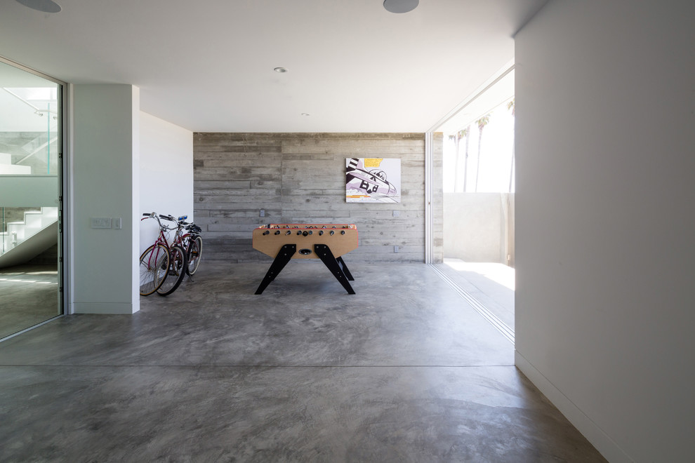 Inspiration for a mid-sized modern walk-out concrete floor basement remodel in Los Angeles with gray walls